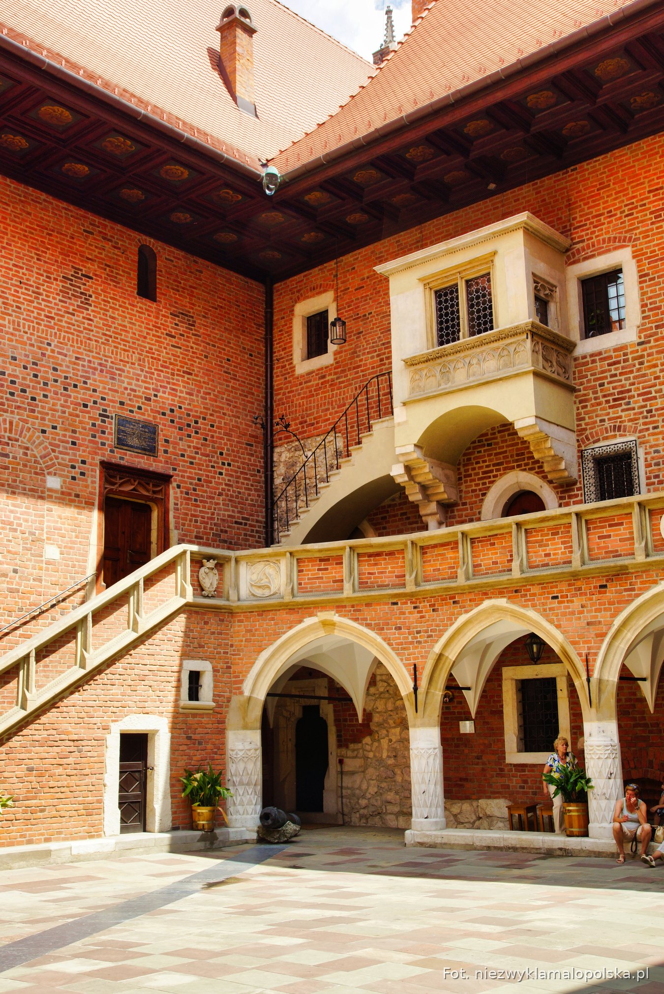 Stone stairs and upper loggia in the brick courtyard of Collegium Maius, Kraków