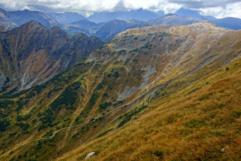 Red autumn slopes of Czerwone Wierchy (Red Peaks) in the Western Tatras with the High Tatras behind
