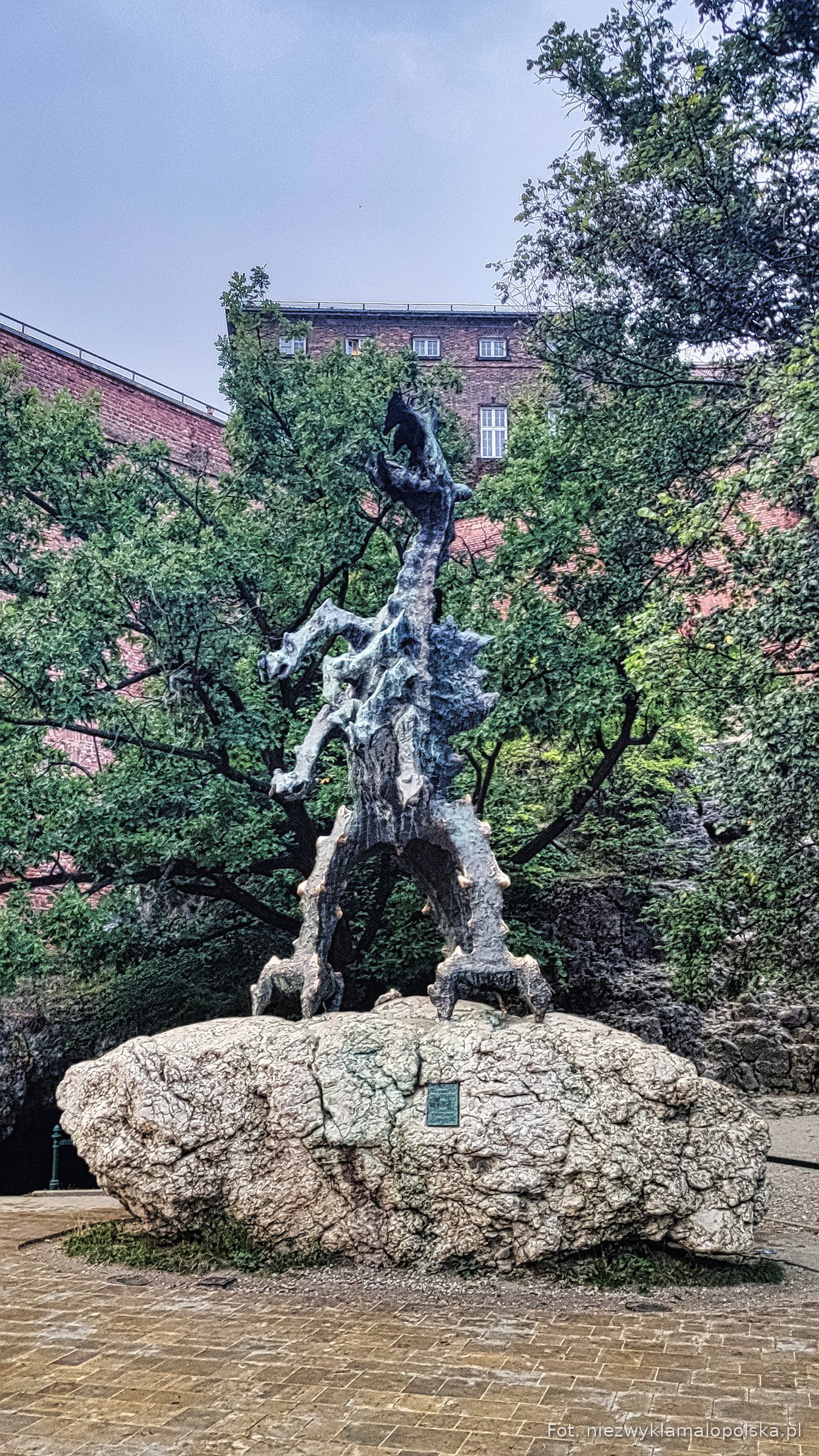 Bronze fire-breathing Wawel Dragon statue by the Vistula in Kraków